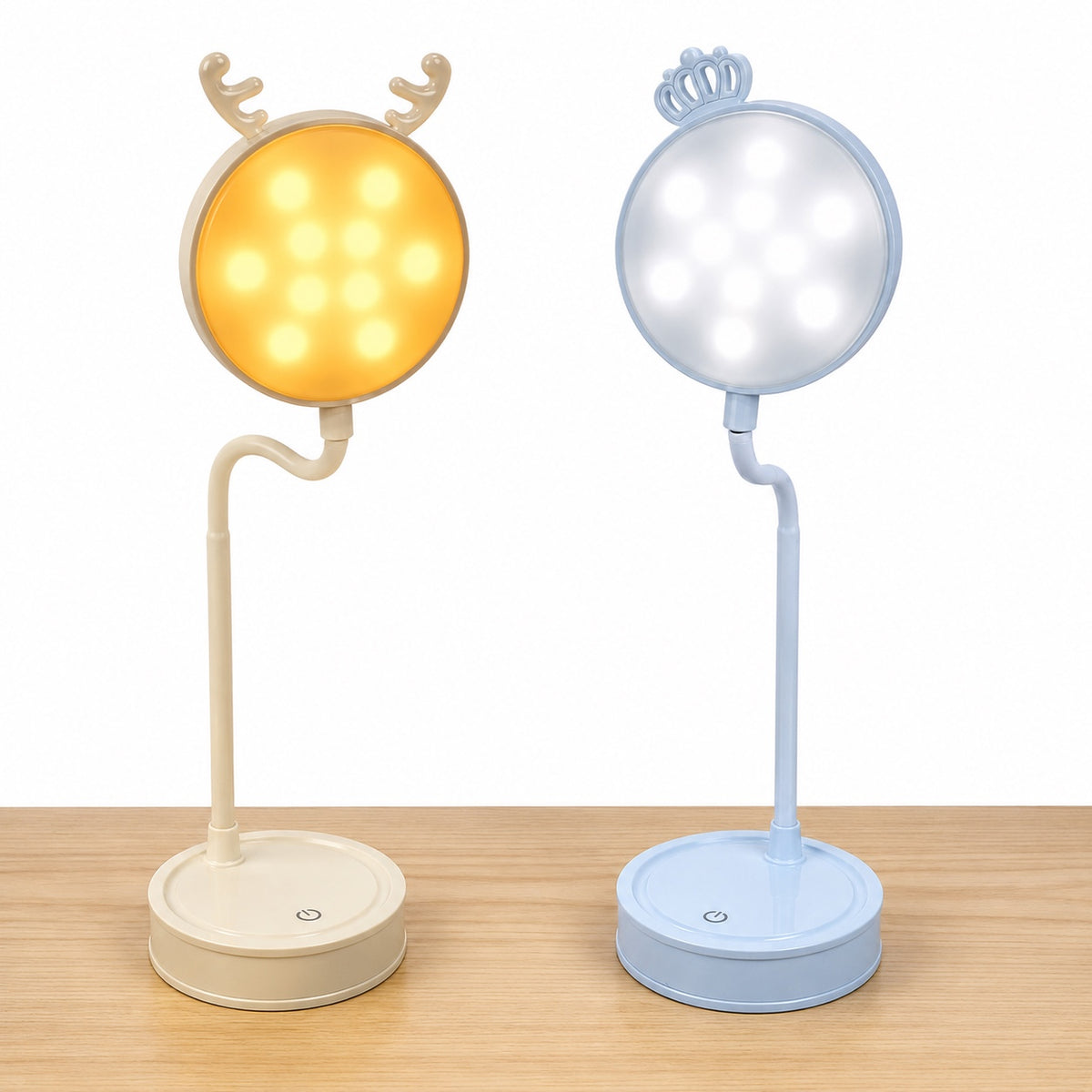 Beige deer and blue crown LED eye-guard desk lamps illuminated on a wooden table